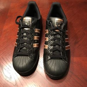 I am selling Adidas Superstars, black & gold.